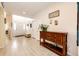 Inviting foyer with light wood floors, a stylish console table, and ample natural light at 22405 E Plymouth Cir, Aurora, CO 80016