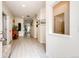 Bright and spacious hallway with light-colored flooring leading to various rooms in the home at 22405 E Plymouth Cir, Aurora, CO 80016