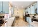 Quaint kitchen featuring blue cabinets, stainless steel appliances, and granite countertops at 22405 E Plymouth Cir, Aurora, CO 80016