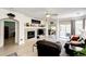 Comfortable living room featuring a fireplace, TV, and sliding doors to outdoor patio at 22405 E Plymouth Cir, Aurora, CO 80016