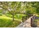 A peaceful view of a charming pond area featuring a decorative foot bridge and plenty of green space at 22405 E Plymouth Cir, Aurora, CO 80016