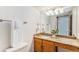 Bathroom featuring a granite countertop, wood cabinets, and decorative frosted glass on the shower door at 831 W Kettle Ave, Littleton, CO 80120