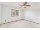 Bedroom featuring neutral carpet, ceiling fan, a window with a tree view, and ample natural light at 831 W Kettle Ave, Littleton, CO 80120