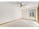 Bedroom with ceiling fan, light-colored walls, carpet, and window with neighborhood view at 831 W Kettle Ave, Littleton, CO 80120