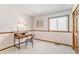 Bedroom featuring wood desk, floral print accent, neutral carpet and a window at 831 W Kettle Ave, Littleton, CO 80120