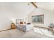 Bedroom featuring vaulted ceiling with beam, large window providing natural light, and neutral decor at 831 W Kettle Ave, Littleton, CO 80120