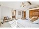 Bedroom featuring vaulted ceiling with beam, open bathroom, and neutral decor at 831 W Kettle Ave, Littleton, CO 80120