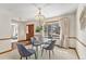 Dining room featuring a glass table, wood floors, and a large window that allows natural light at 831 W Kettle Ave, Littleton, CO 80120