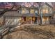 Exterior view of the home featuring a brick facade, two-car garage, and mature trees at 831 W Kettle Ave, Littleton, CO 80120