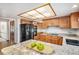 Kitchen featuring granite countertops, black appliances, wood floors, and ample cabinet space at 831 W Kettle Ave, Littleton, CO 80120