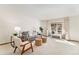 Bright and airy living room with neutral tones and large windows with backyard views at 831 W Kettle Ave, Littleton, CO 80120