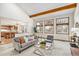 Bright living room with vaulted ceilings, exposed beams, and large windows with backyard views at 831 W Kettle Ave, Littleton, CO 80120