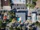 Aerial view features an apartment building with a pool, a parking lot, and a tree-lined street at 33 N Corona St # 205, Denver, CO 80218
