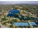 An aerial view showcases a lake, park, tennis courts, and the city skyline in the distance at 33 N Corona St # 205, Denver, CO 80218