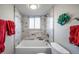 Bright bathroom featuring a clean white bathtub and a window for natural light at 33 N Corona St # 205, Denver, CO 80218