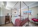 Charming bedroom with a four-poster bed, hardwood floors, and a bright window at 33 N Corona St # 205, Denver, CO 80218