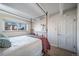 Bright bedroom featuring a four poster bed, light hardwood floors, and large window at 33 N Corona St # 205, Denver, CO 80218