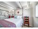 Inviting bedroom with a four-poster bed, white bedding and stylish bedside tables at 33 N Corona St # 205, Denver, CO 80218