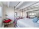 Bedroom features a four-poster bed, wood floors, neutral walls, and mirrored closet at 33 N Corona St # 205, Denver, CO 80218