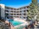 Bright aerial view of the community pool surrounded by the building's apartments, offering a refreshing amenity for residents at 33 N Corona St # 205, Denver, CO 80218