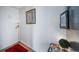A minimalist entryway features neutral-colored walls, a red rug, and light wood flooring at 33 N Corona St # 205, Denver, CO 80218
