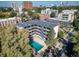 Charming exterior view features a refreshing swimming pool, surrounded by well-maintained apartment buildings and lush trees at 33 N Corona St # 205, Denver, CO 80218
