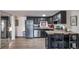 Kitchen with stainless steel appliances, dark cabinets, and hardwood floors is perfect for cooking and entertaining at 33 N Corona St # 205, Denver, CO 80218