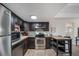 Well-equipped kitchen with stainless steel appliances, dark cabinetry, and a functional layout at 33 N Corona St # 205, Denver, CO 80218