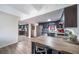Modern kitchen with stainless steel appliances and a breakfast bar with butcher block countertop at 33 N Corona St # 205, Denver, CO 80218