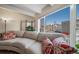 Bright living room with a large window, neutral couch, and decorative pillows at 33 N Corona St # 205, Denver, CO 80218