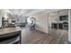 Open-concept living area with an attached kitchen, hardwood floors, and lots of sunlight at 33 N Corona St # 205, Denver, CO 80218