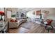 Bright living room with a curved sofa, hardwood floors, large windows, and stylish décor at 33 N Corona St # 205, Denver, CO 80218
