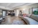 Living room with hardwood floors that seamlessly connects to the modern kitchen with stainless steel appliances at 33 N Corona St # 205, Denver, CO 80218