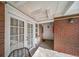 A quaint patio area has brick walls, and is accessible through glass doors with white frames at 33 N Corona St # 205, Denver, CO 80218