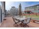 Back deck with outdoor seating and an umbrella, overlooking the lawn and neighboring homes at 2347 Switch Grass Way, Castle Rock, CO 80109