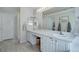 Bright bathroom boasting dual sinks, a spacious vanity, and stylish wood-look flooring at 2347 Switch Grass Way, Castle Rock, CO 80109