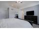 Bright and airy bedroom with vaulted ceilings, neutral color scheme, and a glimpse into the bathroom at 2347 Switch Grass Way, Castle Rock, CO 80109