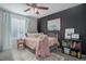 Bright bedroom with a ceiling fan, black accent wall, and cozy decor at 2347 Switch Grass Way, Castle Rock, CO 80109