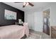 Cozy bedroom featuring a black accent wall and view into the hallway at 2347 Switch Grass Way, Castle Rock, CO 80109