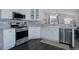 Modern kitchen with stainless steel appliances, white cabinets, and tile backsplash at 2347 Switch Grass Way, Castle Rock, CO 80109