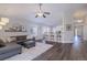 Bright living room with modern furnishings, hardwood floors, and a ceiling fan at 2347 Switch Grass Way, Castle Rock, CO 80109