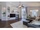 Spacious living room featuring a fireplace, ceiling fan, and large windows for natural light at 2347 Switch Grass Way, Castle Rock, CO 80109