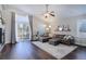 Spacious living room with sliding glass doors to patio, dark wood floors and modern decor at 2347 Switch Grass Way, Castle Rock, CO 80109