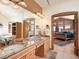Primary bathroom featuring double vanities, granite counters, and a doorway to the bedroom at 76 Raven Ridge Rd, Idaho Springs, CO 80452