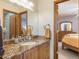 Bathroom features a vanity with marble countertop and leads into a bedroom at 76 Raven Ridge Rd, Idaho Springs, CO 80452