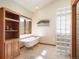 Bright bathroom featuring a clawfoot tub, wooden shelving and shower with glass block accents at 76 Raven Ridge Rd, Idaho Springs, CO 80452