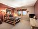 Bedroom features a rustic wooden bed frame and scenic mountain views at 76 Raven Ridge Rd, Idaho Springs, CO 80452