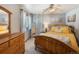 Bedroom features a wooden bed frame with neutral tones and natural lighting at 76 Raven Ridge Rd, Idaho Springs, CO 80452