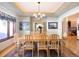 Formal dining area with seating for eight, a tray ceiling with accent lighting, and bright natural light at 76 Raven Ridge Rd, Idaho Springs, CO 80452