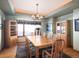 Cozy dining area with wood table, seating for eight, overhead lighting, and built-in cabinets for storage at 76 Raven Ridge Rd, Idaho Springs, CO 80452